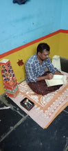 Load image into Gallery viewer, Traditional Tholu Bomalatta artist Sh. Dalavai Raju at work